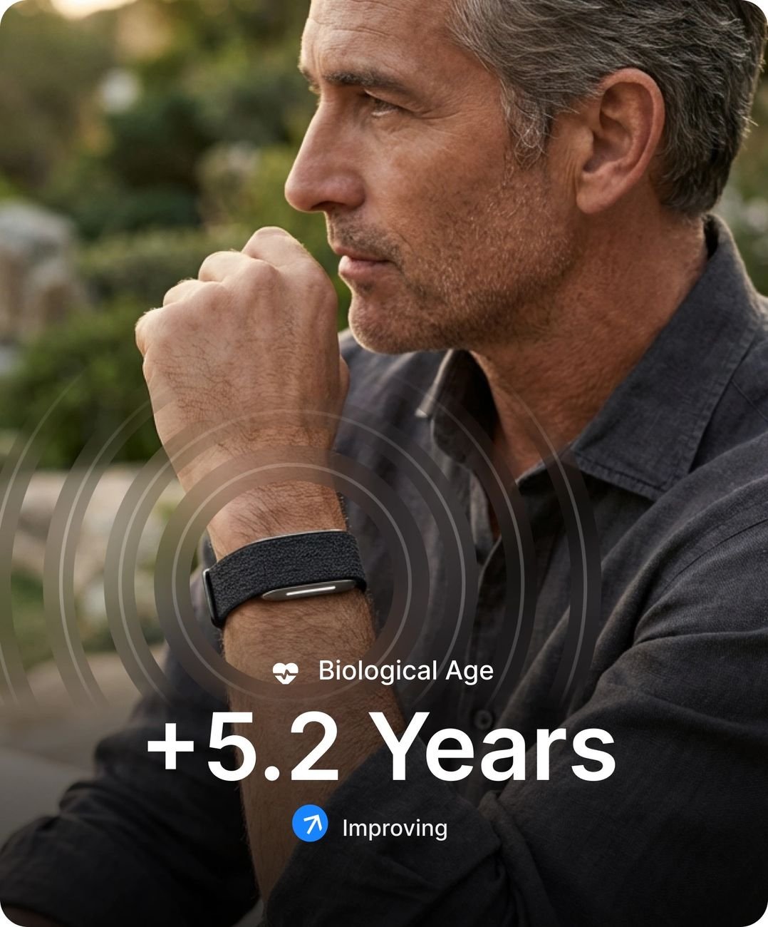 Man wearing the Hume Band with biological age and chronic illness risk shown in app